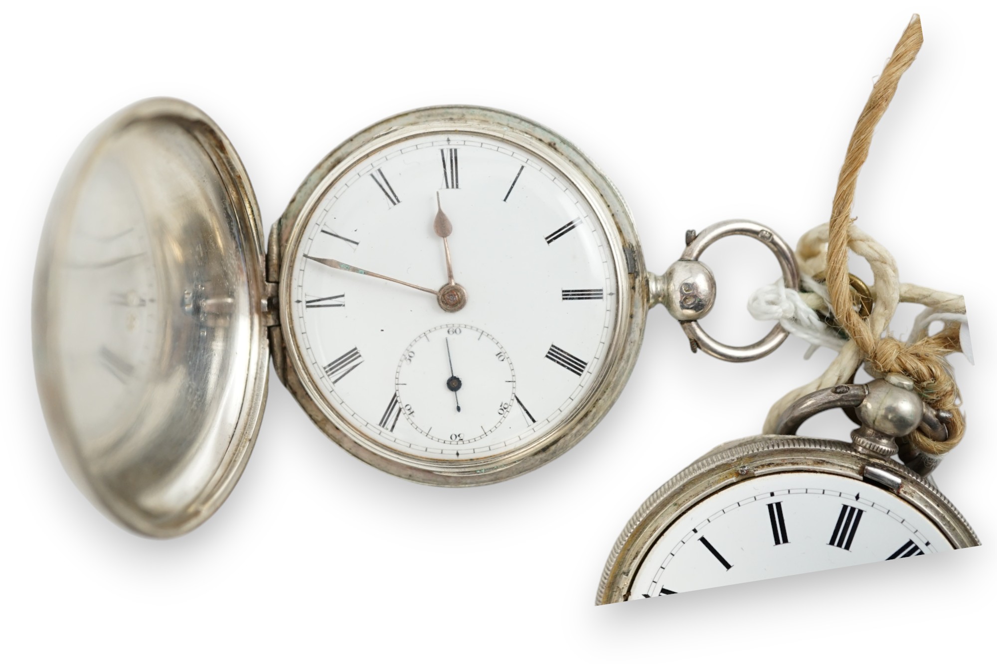 A Victorian silver hunter keywind pocket watch and an engine turned white metal pocket watch.